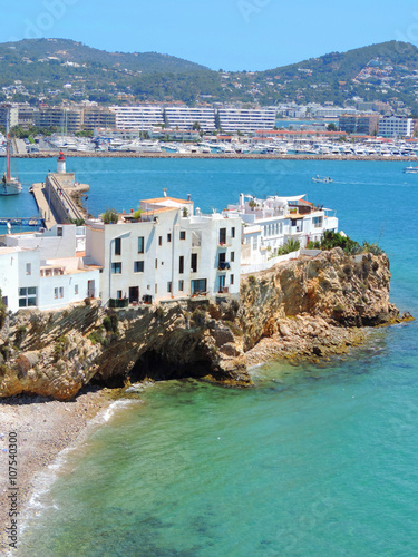 Sa Penya, Ibiza Town with old houses at a cliff coast photo