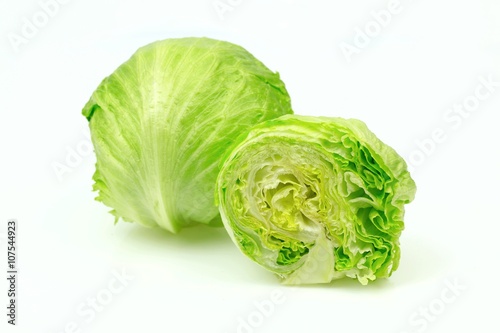 Iceberg lettuce and one cut half, on white background.