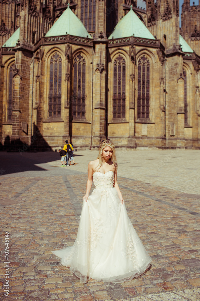 Obraz premium Beautiful blonde bride posing near baroque christian cathedral i