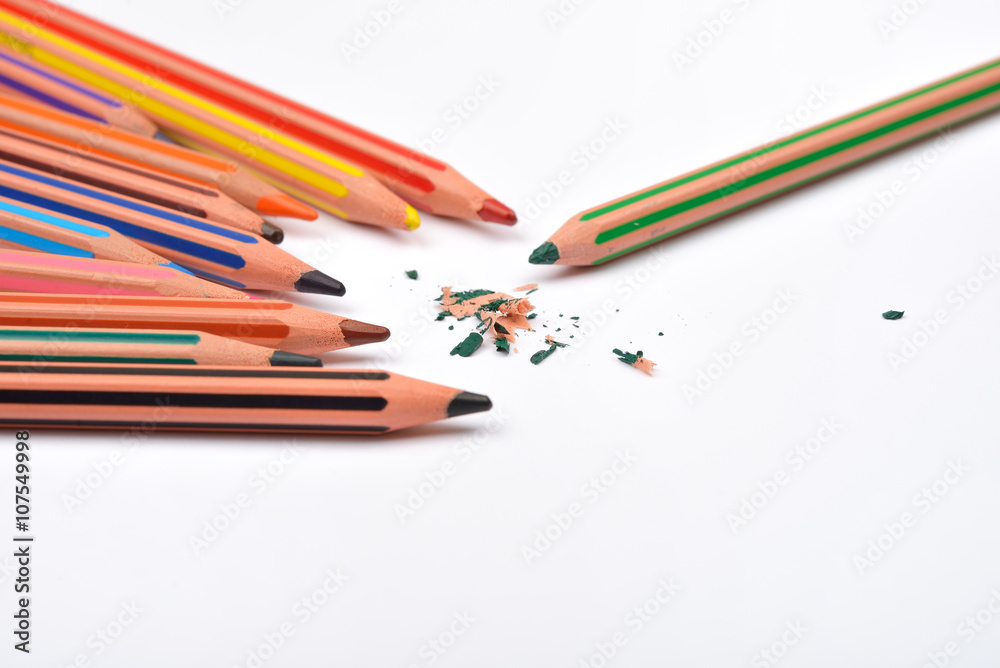 Picture of some pencils with stripes of different colors and pen