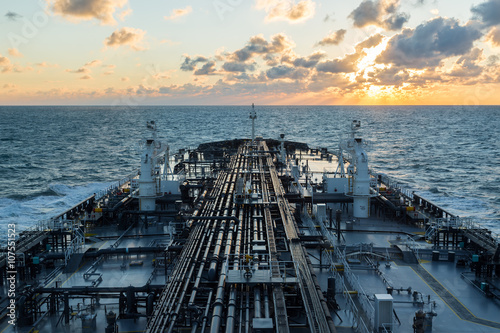 Oli tanker under sunset sky.