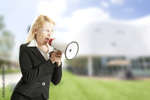 Angry businesswoman screaming very loud photo