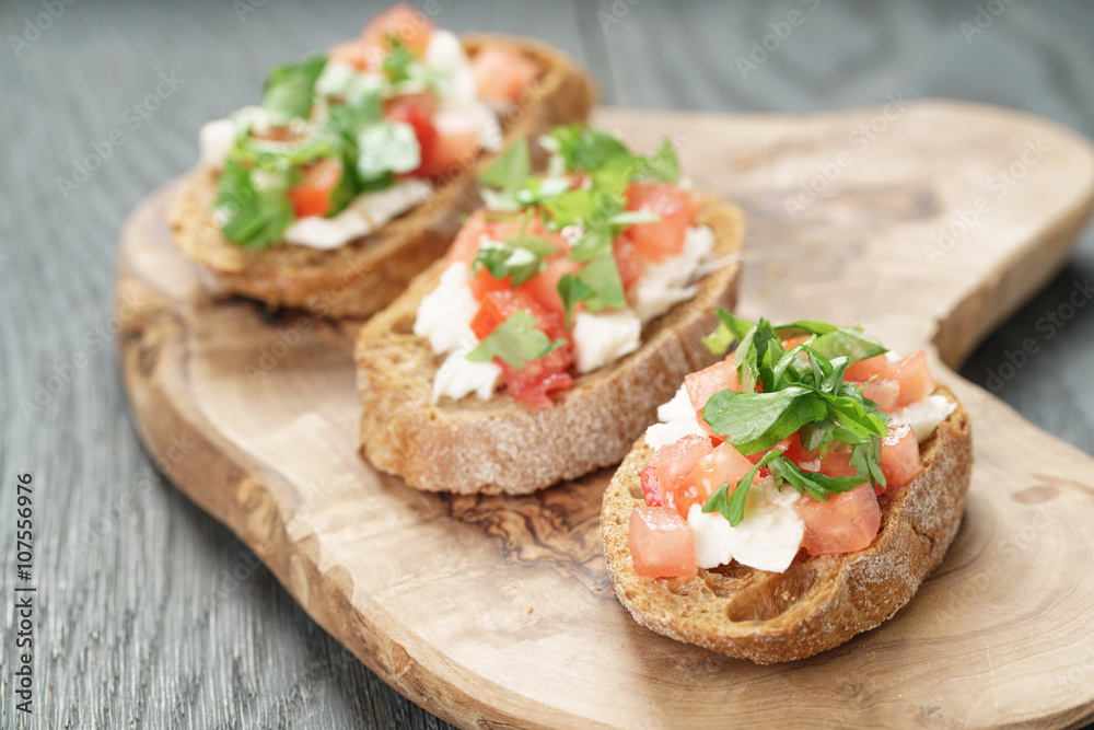 homemade bruschetta with cheese and vegetables, shallow focus