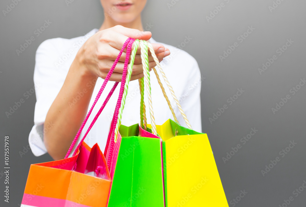 Concept of woman shopping and holding bags, closeup image.

