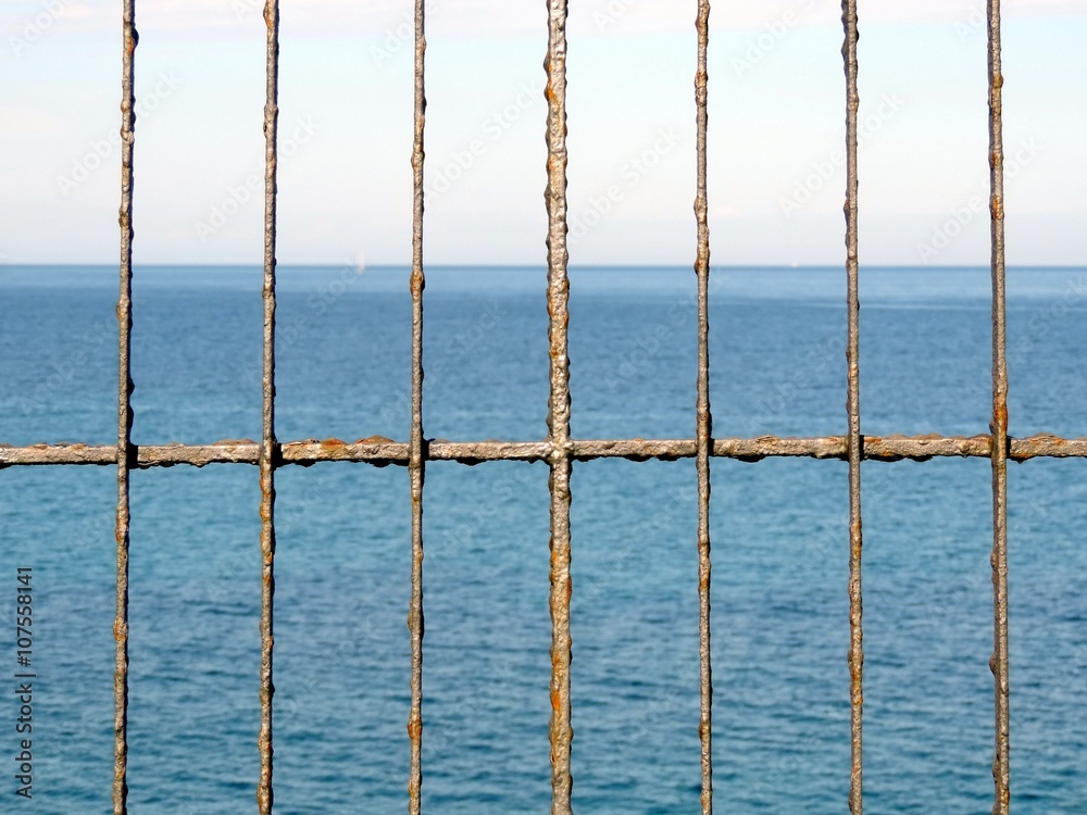 Rusty fence in front of the sea. Rusty fence in front of the sea.