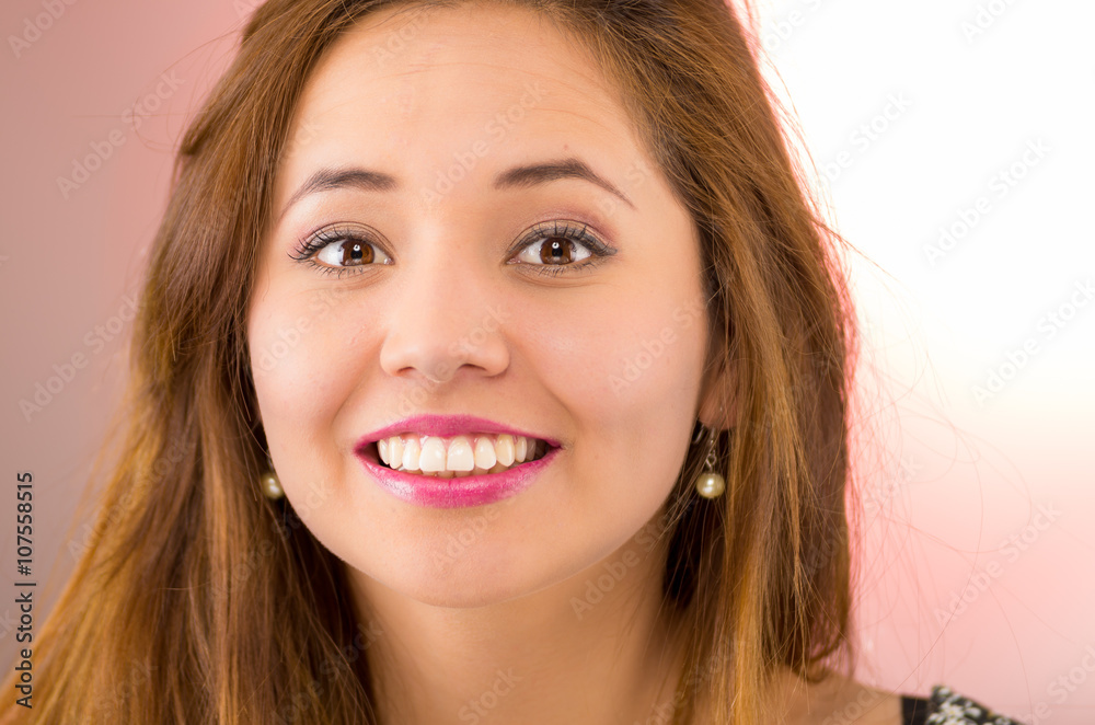 Headshot young pretty hispanic woman brunette with red lipstick, smiling to camera, pink background Headshot young pretty hispanic woman brunette with red lipstick, smiling to camera, pink background