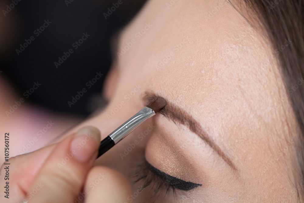Close up of a woman putting on a make up