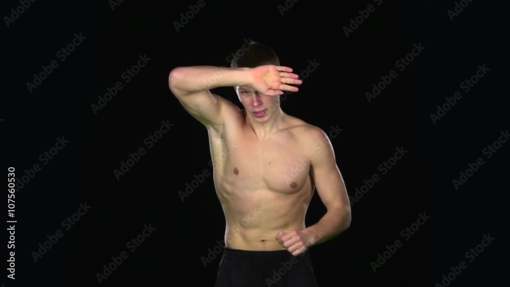 Sprinting runner man at fast speed. Black. Slow motion Sprinting runner man at fast speed. Black. Slow motion