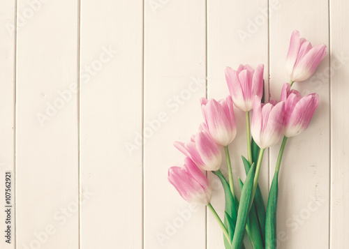 Pink tulips over white wood