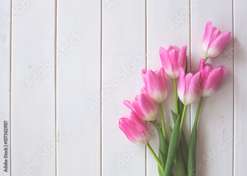 Fototapeta Naklejka Na Ścianę i Meble -  Pink tulips over white wood