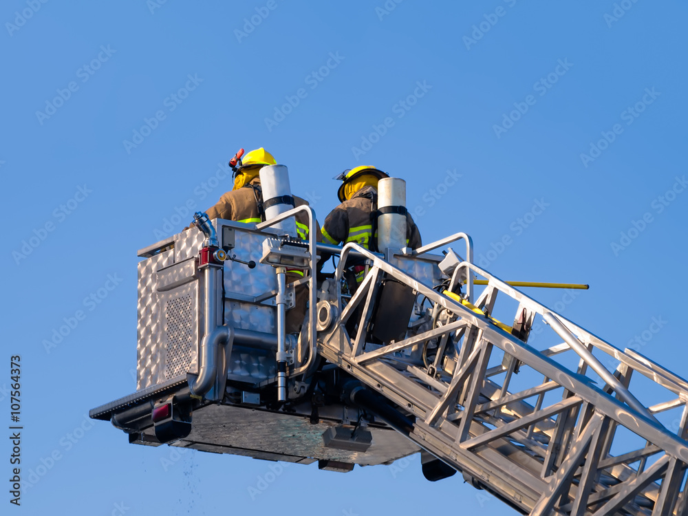 Firefighters on platform isolated on blue sky
