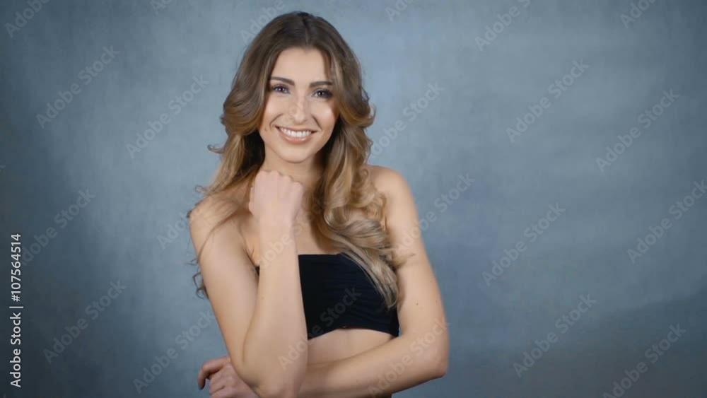 Happy young woman with perfect smile isolated on grey background. Happy young woman with perfect smile isolated on grey background.