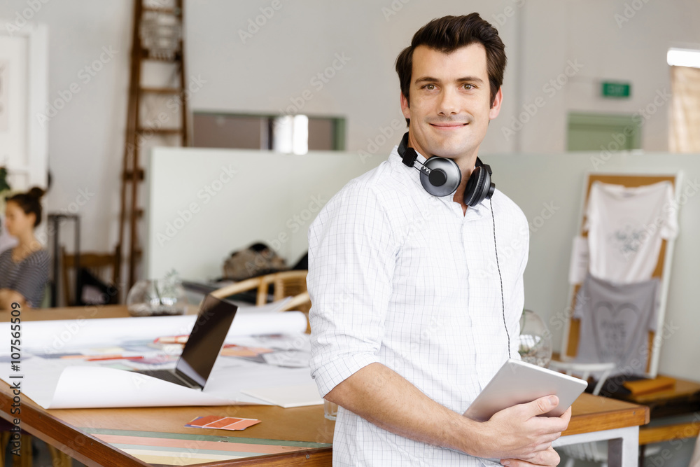 Young man standing in creative office Young man standing in creative office