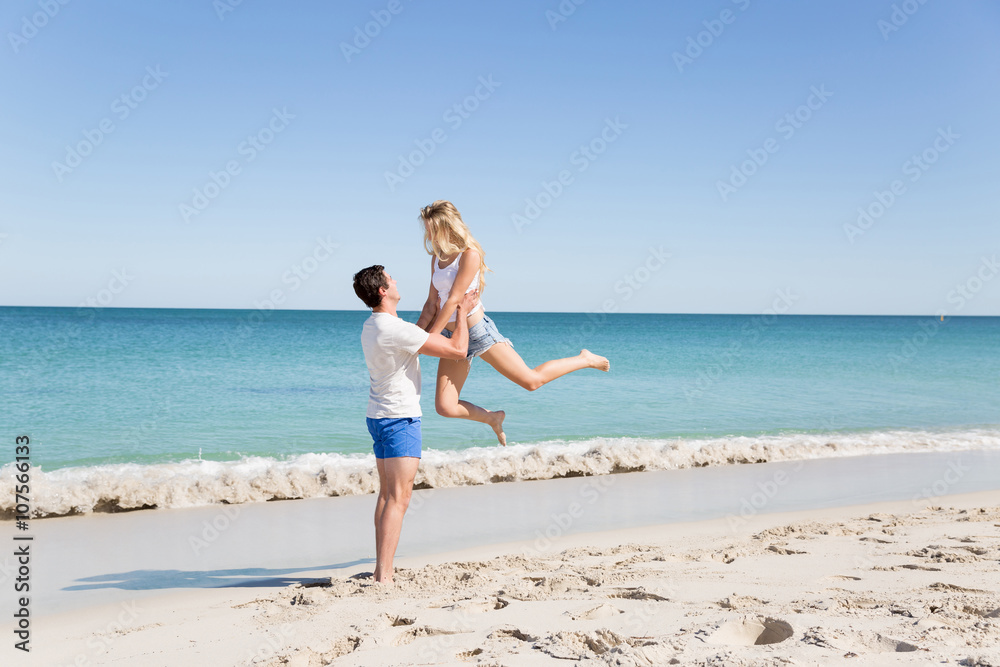 Happy couple jumping on beach vacations Happy couple jumping on beach vacations
