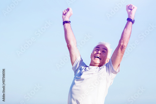 Young man in sport wear with outstretched arms