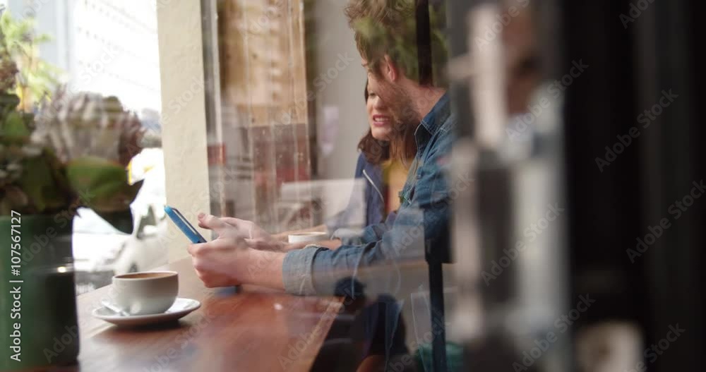Woman and Man sitting in coffee shop with Tablet