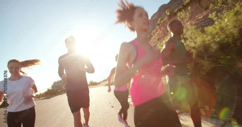 Group of athletic friends running outdoors