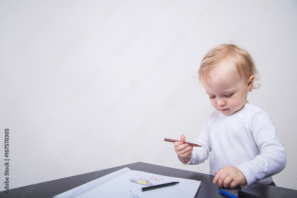 Baby girl drawing with colorful felt-tip pens white background Baby girl drawing with colorful felt-tip pens white background