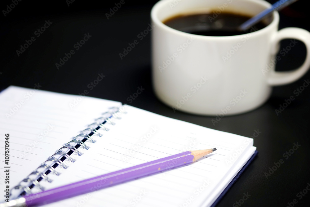 Purple pencil and notebook open on the table. Purple pencil and notebook open on the table.