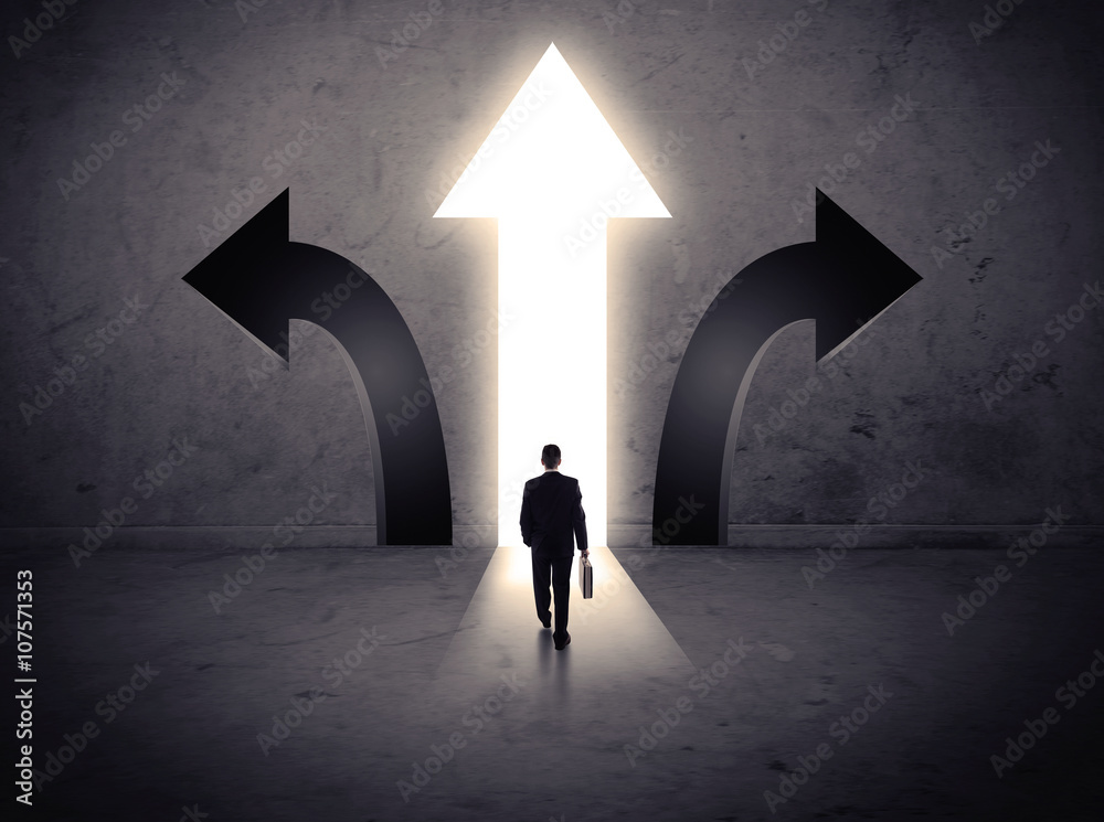 Businessman in front of three arrows