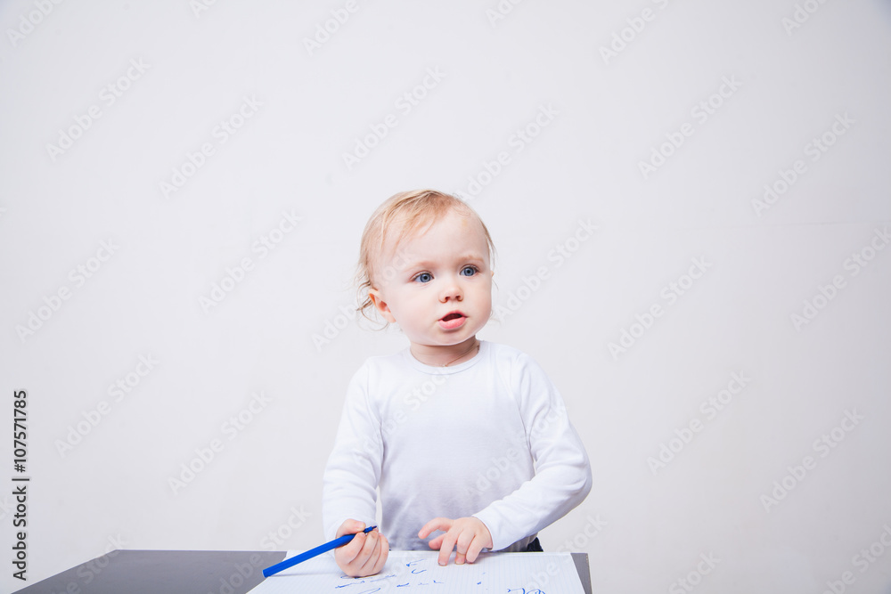 Baby girl drawing with colorful felt-tip pens on white background Baby girl drawing with colorful felt-tip pens on white background
