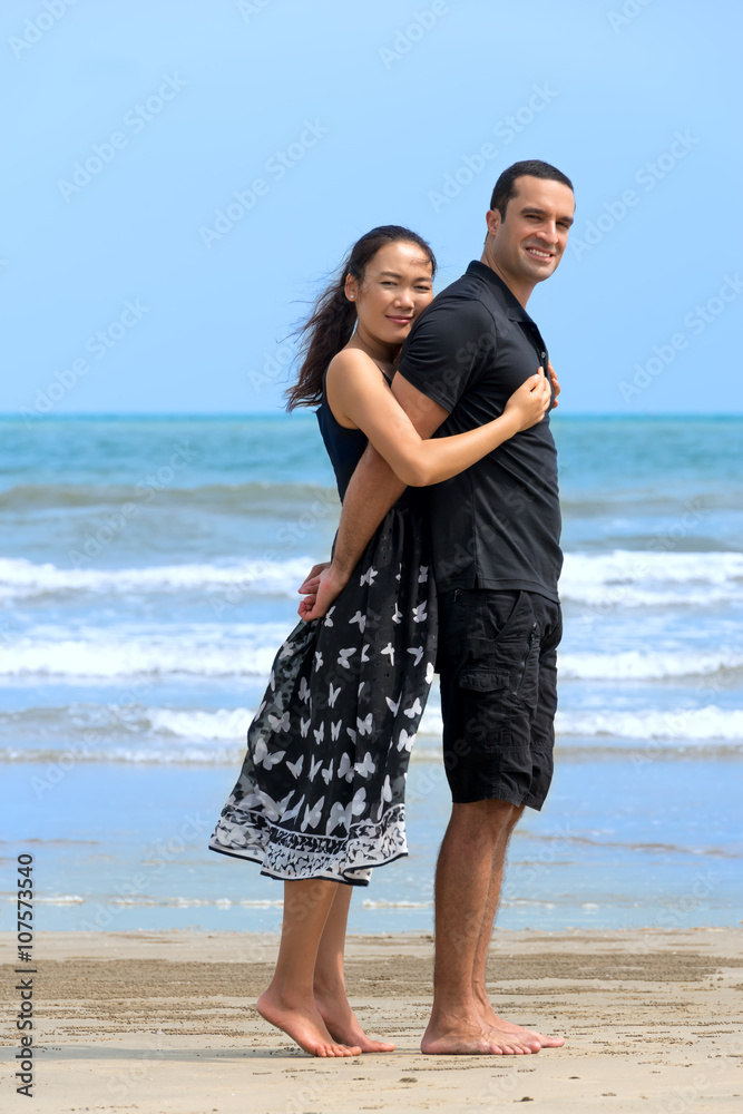 Happy interracial couple on beach Happy interracial couple on beach