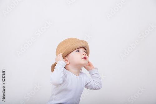 Little girl with hat on a white background.