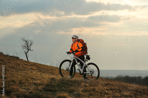 Man cyclist with backpack riding the bicycle