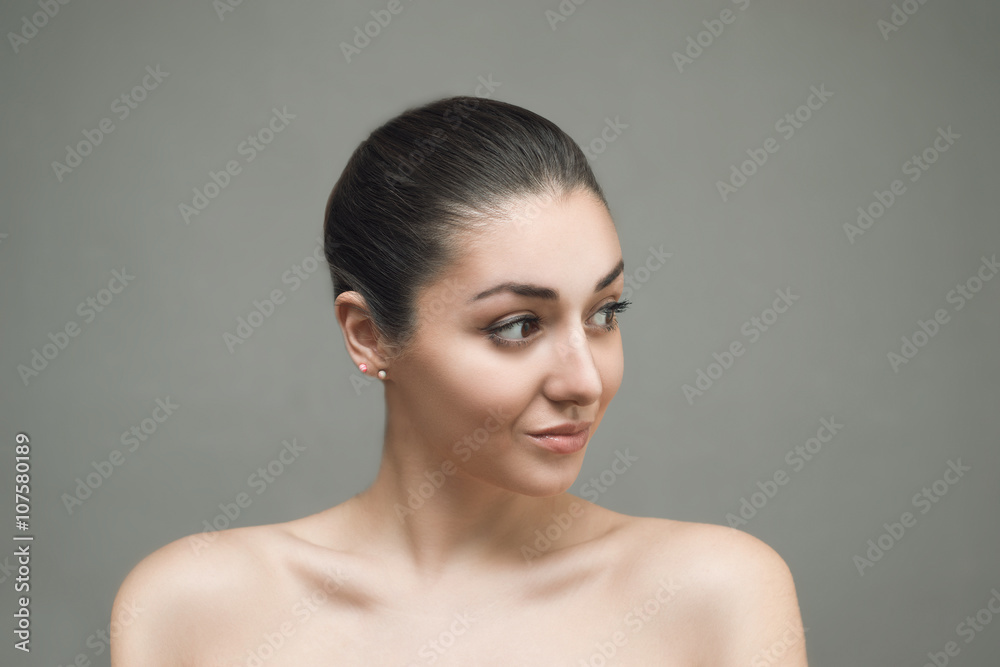 Beautiful Face of Young Woman with Clean Fresh Skin close up isolated on gray. Beauty Portrait. Beautiful Spa Woman Smiling. Perfect Fresh Skin. Pure Beauty Model. Youth and Skin Care Concept Beautiful Face of Young Woman with Clean Fresh Skin close up isolated on gray. Beauty Portrait. Beautiful Spa Woman Smiling. Perfect Fresh Skin. Pure Beauty Model. Youth and Skin Care Concept