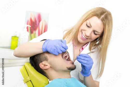 Dentist is working on the patient at the dentist office. Dental care and health care concept