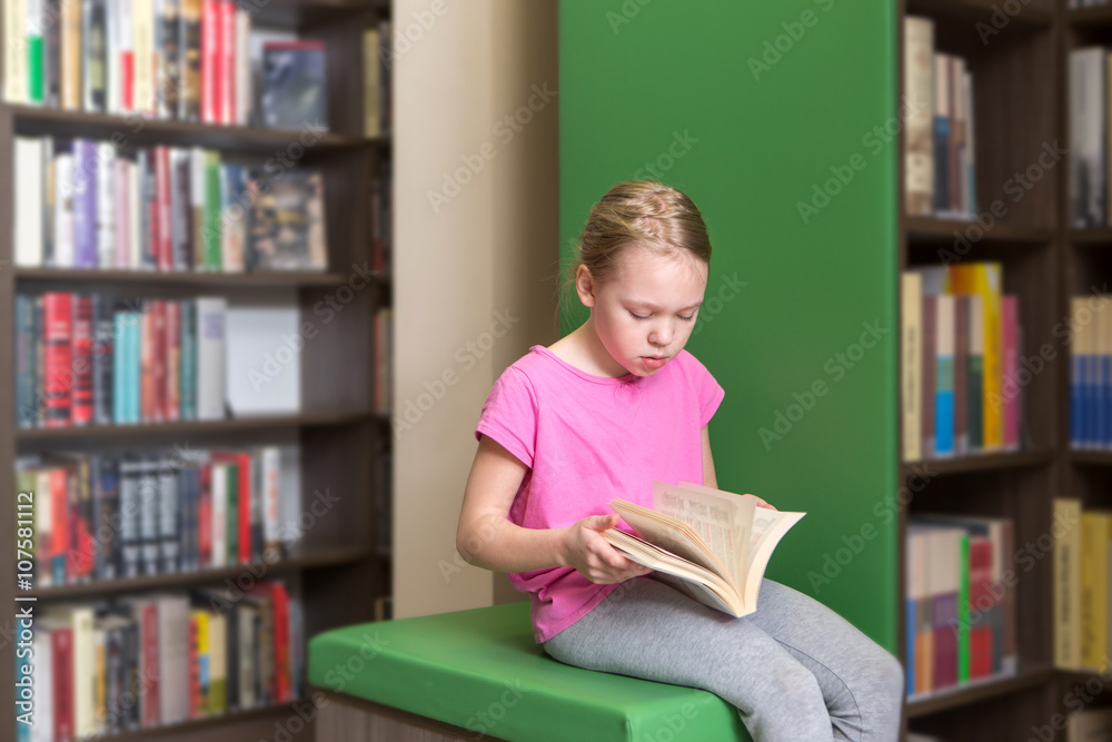 Cute girl reading book in library
Cute girl reading book in library