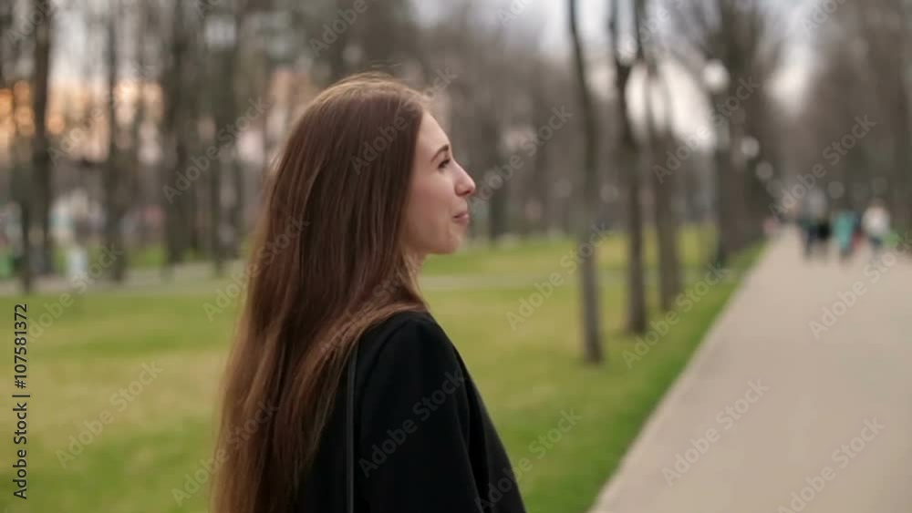 Young pretty girl with a black hat smiles happily into camera, close up, slow motion Young pretty girl with a black hat smiles happily into camera, close up, slow motion