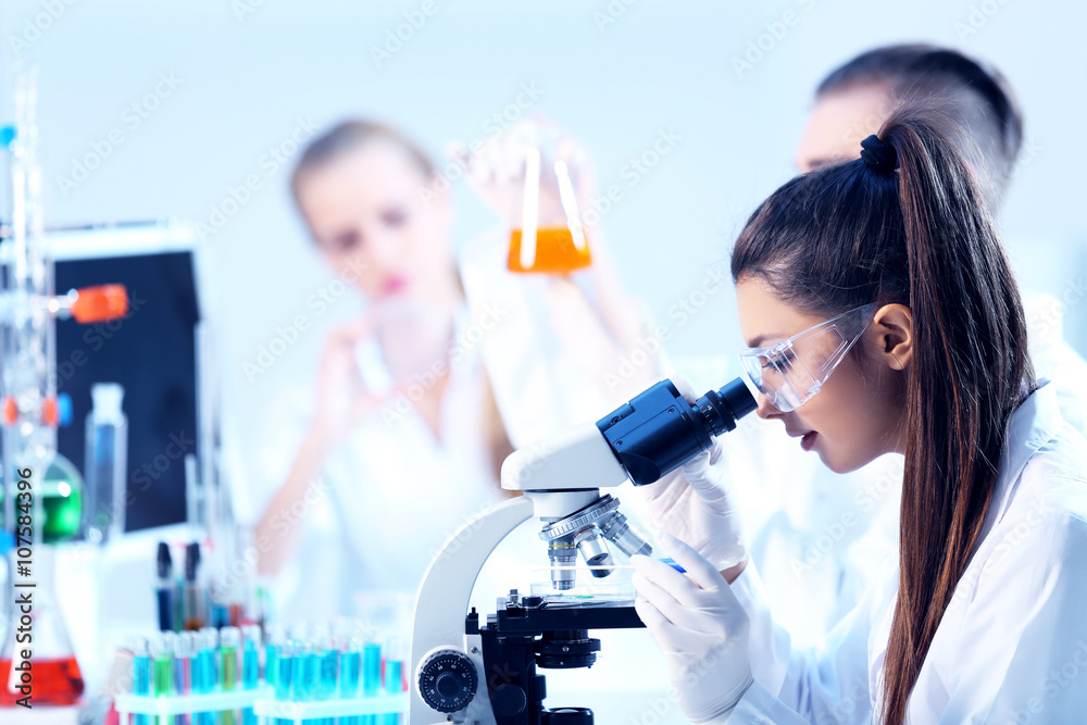 Young medical technicians working in laboratory Young medical technicians working in laboratory