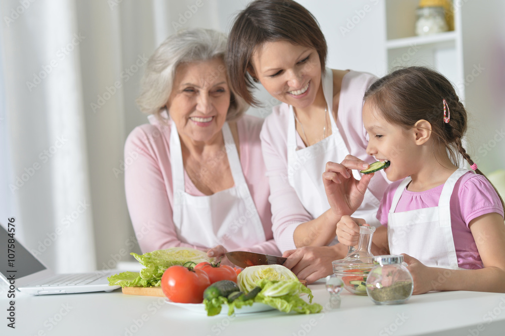 women with little girl cooking