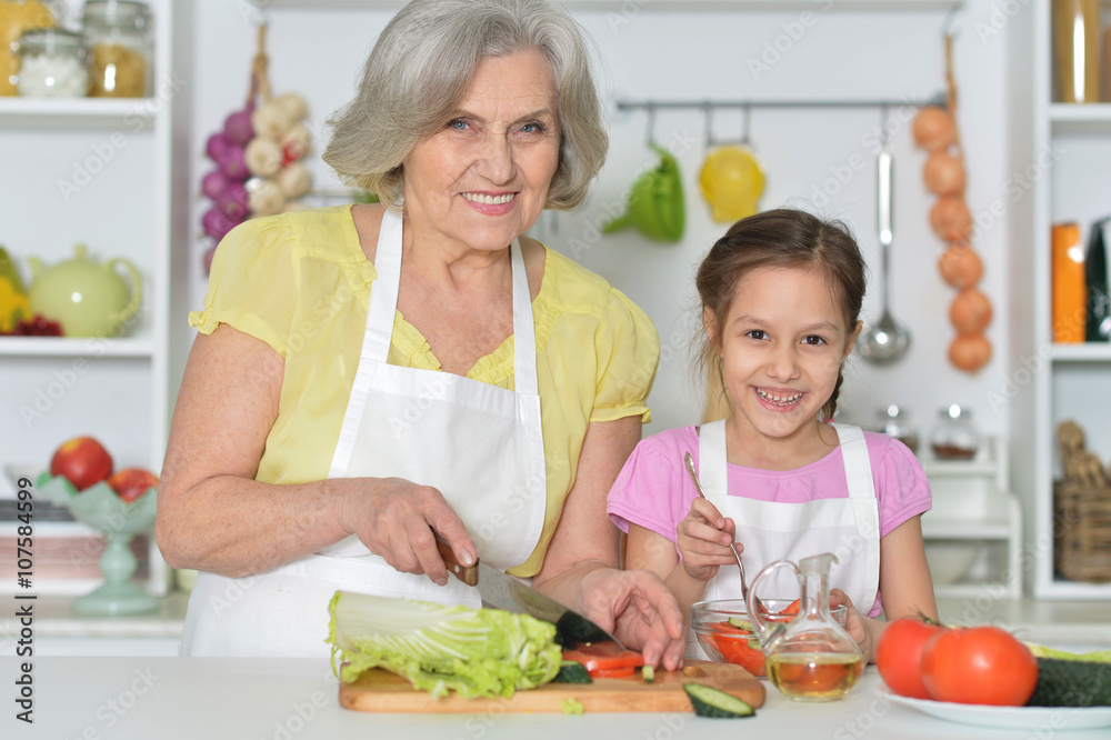 Senior woman with granddaughter cooking Senior woman with granddaughter cooking