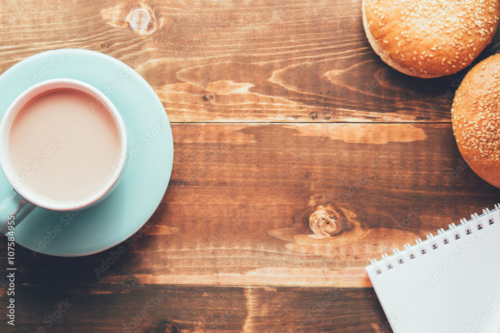 Notebook with a pen on the table next to cacao