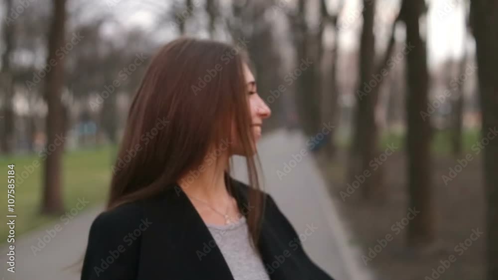 Young pretty girl with a black hat smiles happily into camera, close up, slow motion Young pretty girl with a black hat smiles happily into camera, close up, slow motion