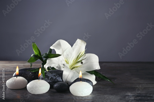 Spa still life with beautiful flower and candlelight on grey background