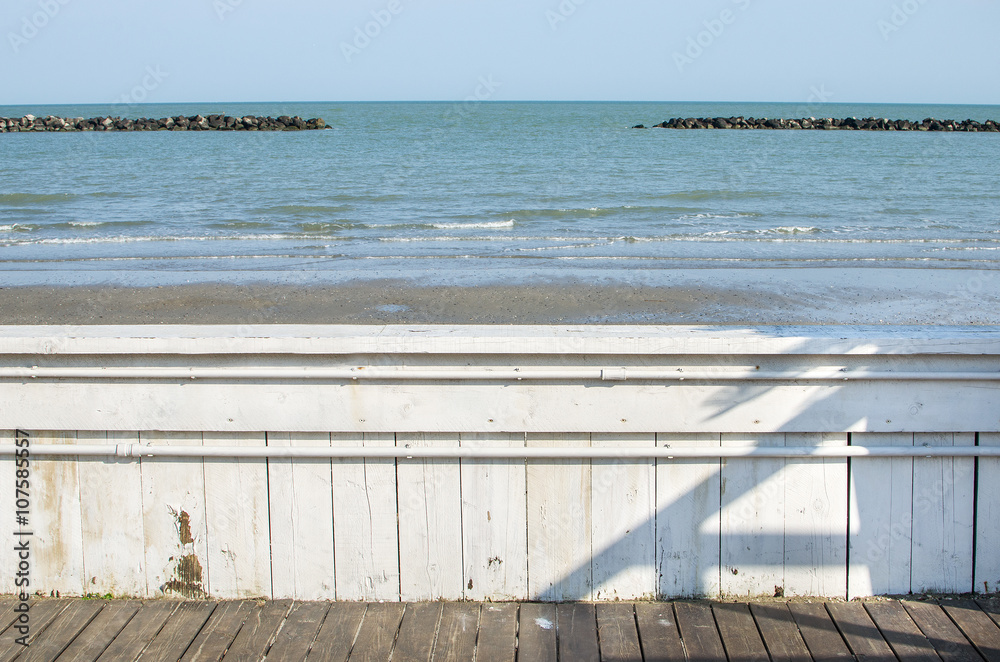 white wood fence overlook sea  artificial skerry shoreline walkw