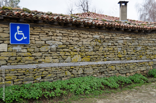 invalid parking sign on old stone wall photo