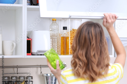 Young woman taking clean di...