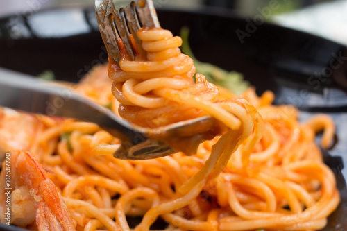 close up tasty tomato-sauce spaghetti with fork