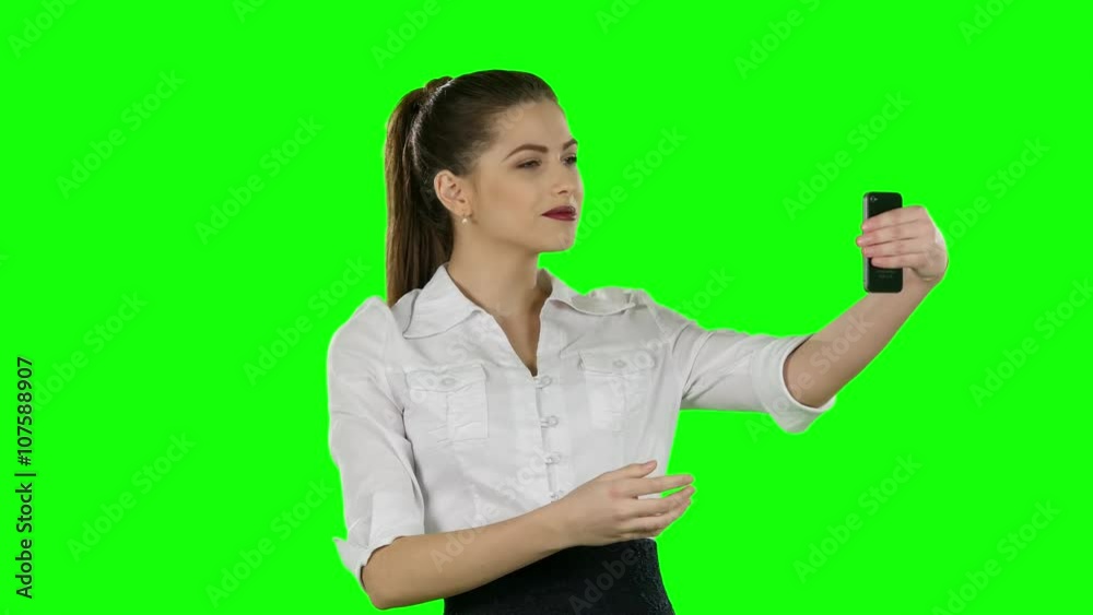 Businesswoman photographs with phone. Green screen Businesswoman photographs with phone. Green screen