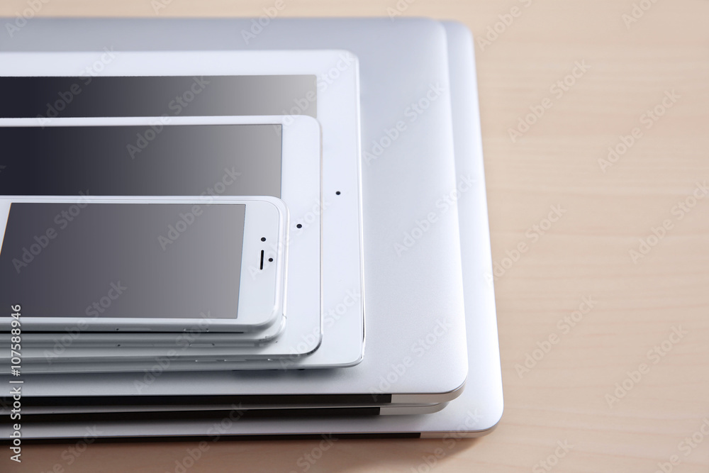 Stack of electronic device on wooden table Stack of electronic device on wooden table