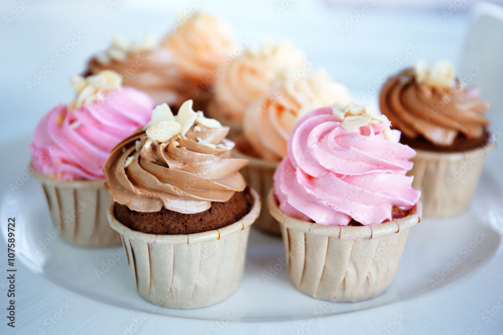 Creamy cupcakes on table closeup