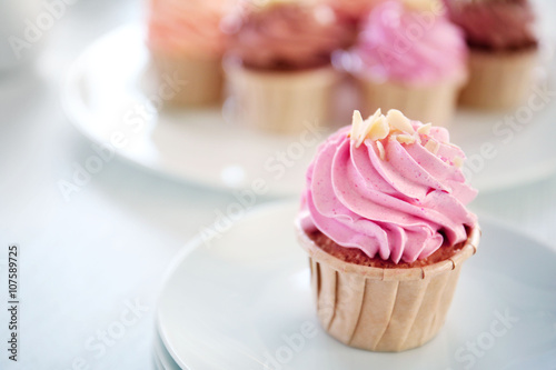 Creamy cupcakes on table closeup