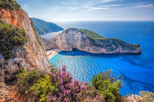 Navagio beach with shipwreck and flowers against sunset on Zakynthos island in Greece photo