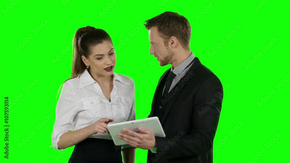 Two office worker look at a laptop together. Online shopping, Green screen Two office worker look at a laptop together. Online shopping, Green screen