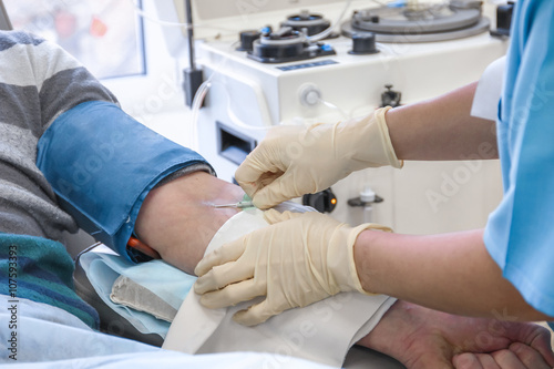 The process of sampling from the donor plasma. Insert the needle into the elbow bend