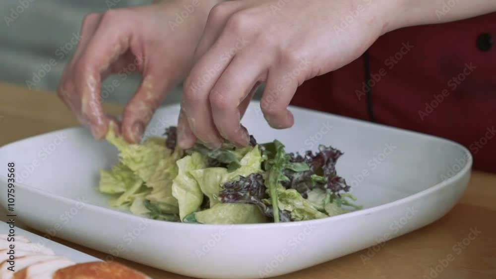 Close Up putting lettuce with mayonnaise into bowl Close Up putting lettuce with mayonnaise into bowl